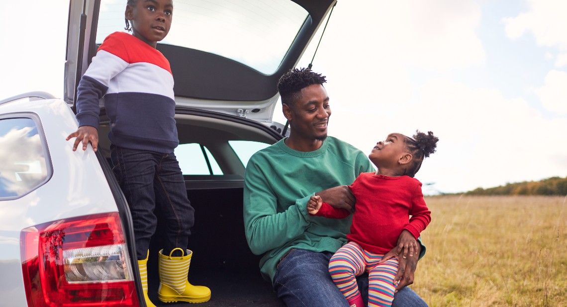 family sat in the boot of a motability car