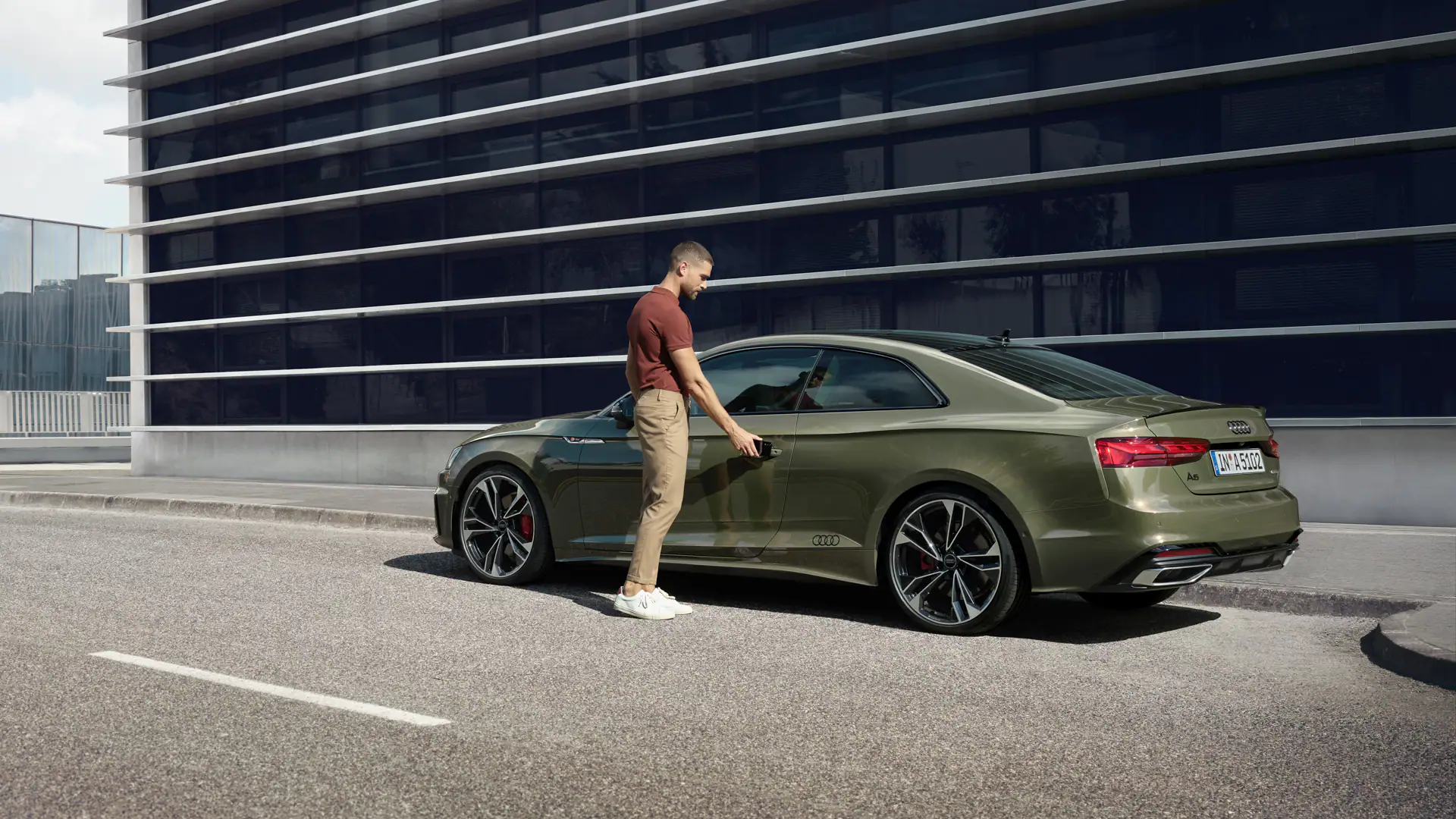 Green Audi A5 Coupe rear angle parked