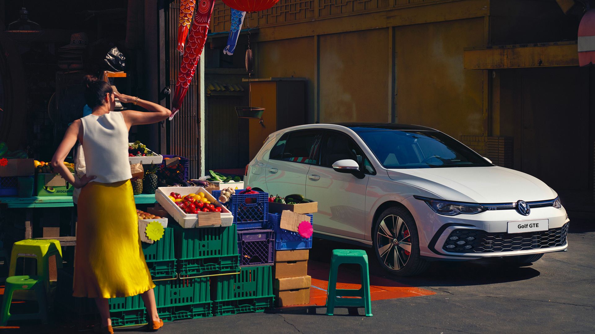 golf gte parked next to fruit stall