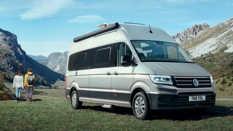 Volkswagen Grand California parked on grass