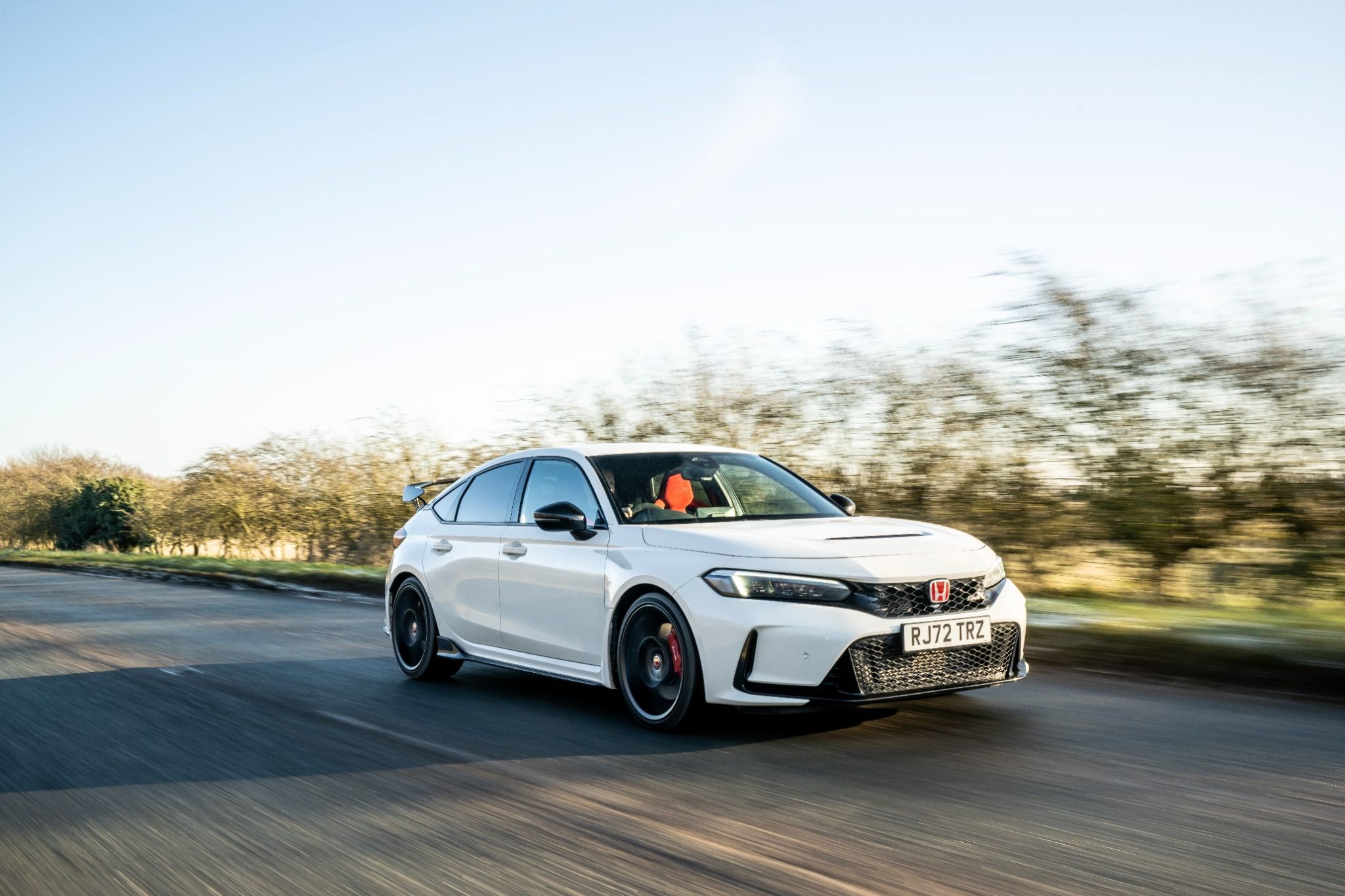 Front view of New Honda Civic Type R driving on a road