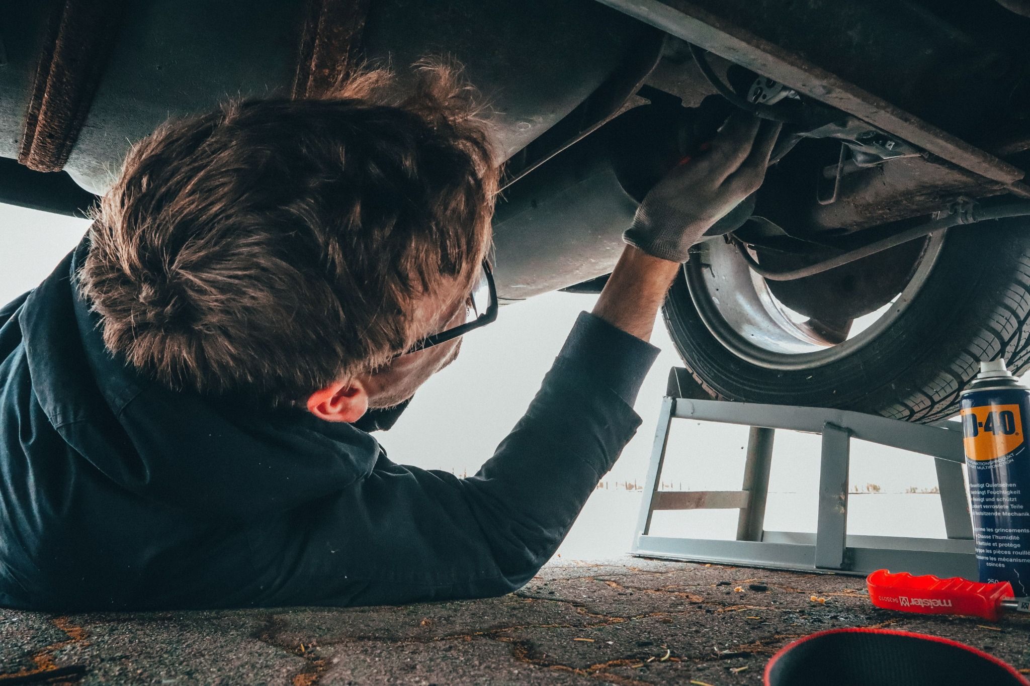 Technician working under a car