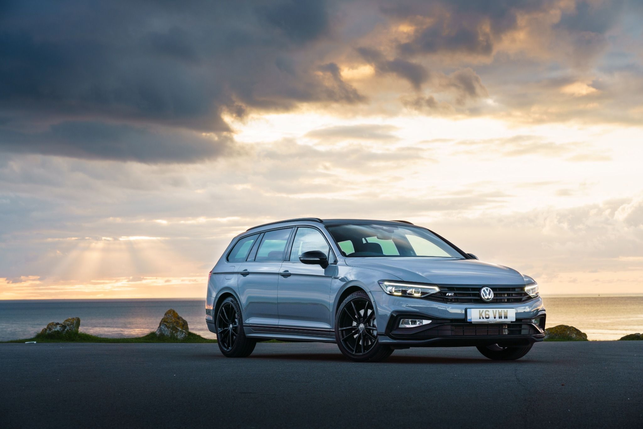 Volkswagen Passat estate in blue parked in front of a sunset view