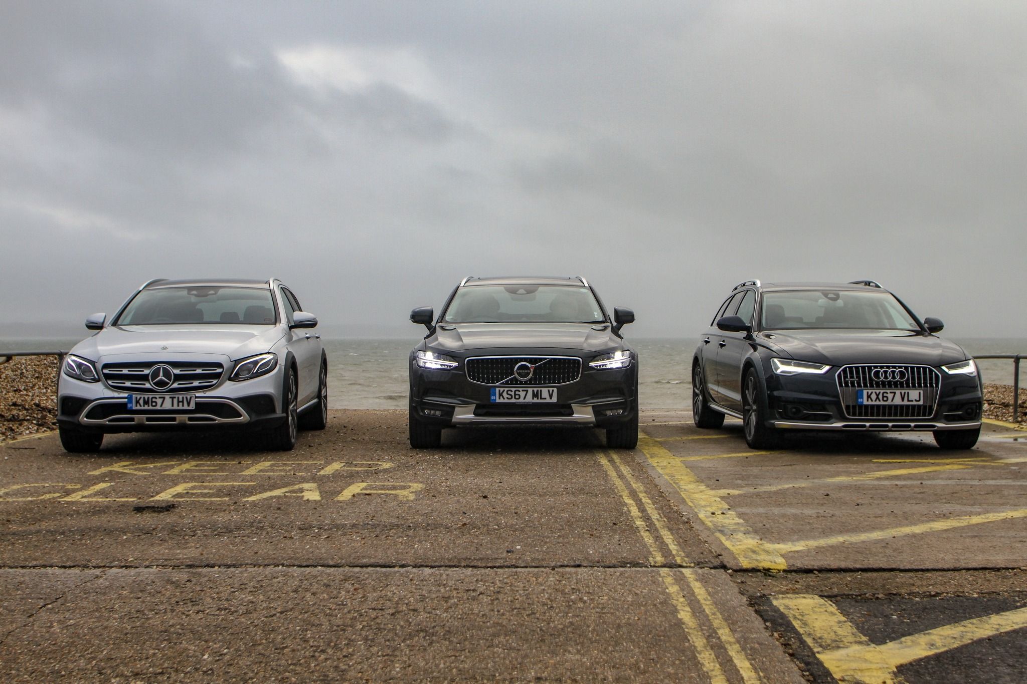 Mercedes E class, Volvo V90 and Audi A6 Allroad parked on a road